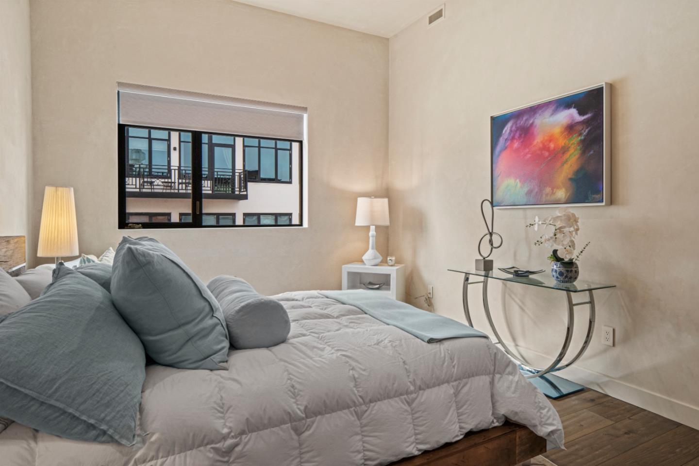 520 Lighthouse Avenue, Unit 301 Pacific Grove, CA 93950 - Photo 18 of 23 a spacious bedroom with a bed a couch and large window