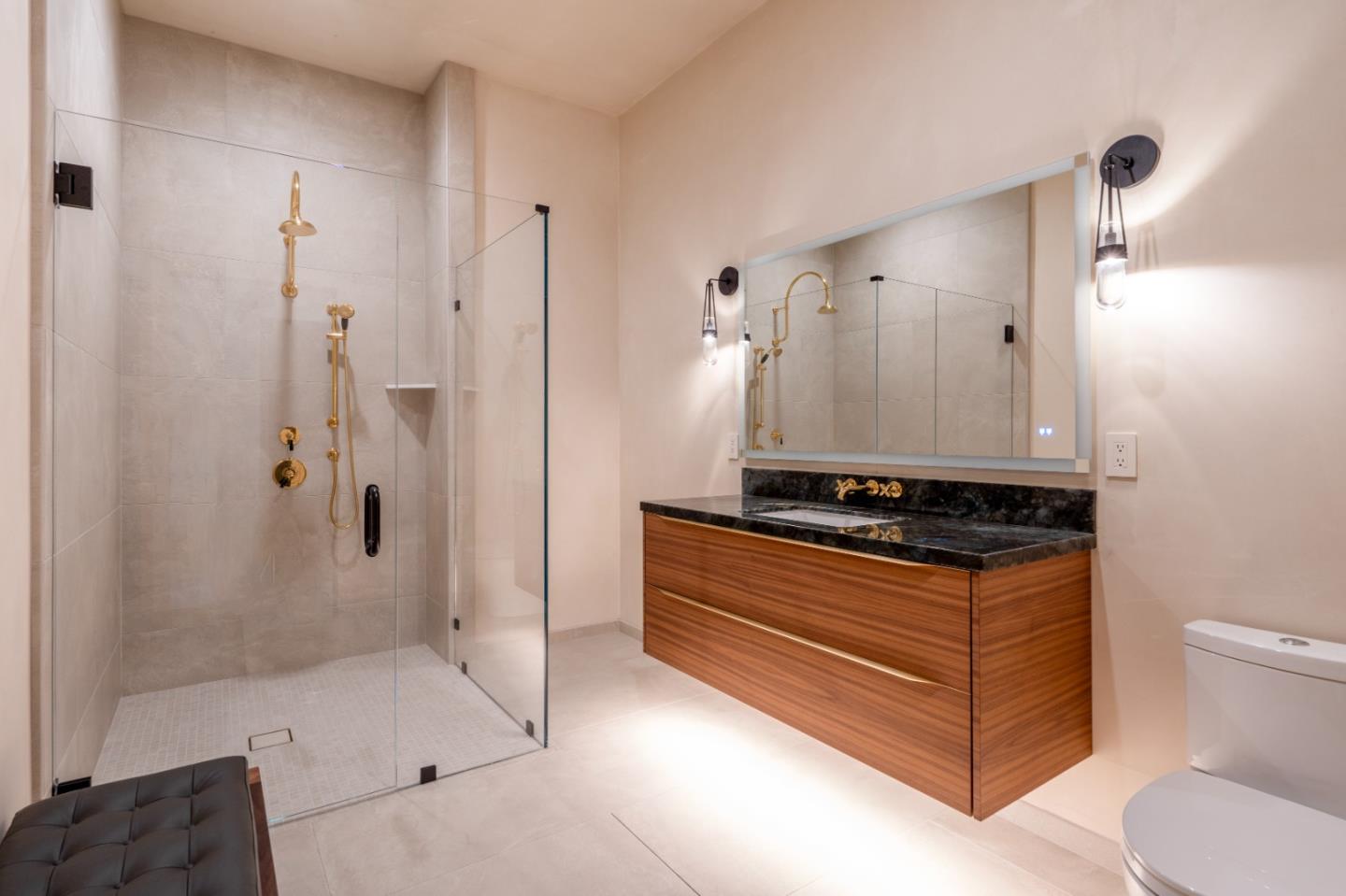 520 Lighthouse Avenue, Unit 301 Pacific Grove, CA 93950 - Photo 19 of 23 a bathroom with a granite countertop sink a toilet and shower