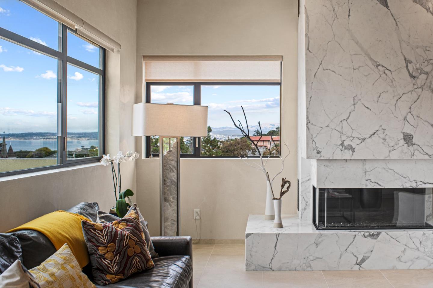 520 Lighthouse Avenue, Unit 301 Pacific Grove, CA 93950 - Photo 2 of 23 a bedroom with furniture and a fireplace