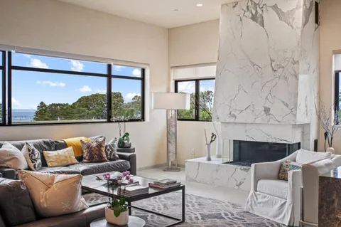 a living room with furniture and a floor to ceiling window