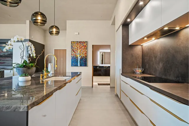a large kitchen with a large counter top space and stainless steel appliances