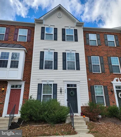 a kitchen with kitchen island granite countertop stainless steel appliances and wooden cabinets