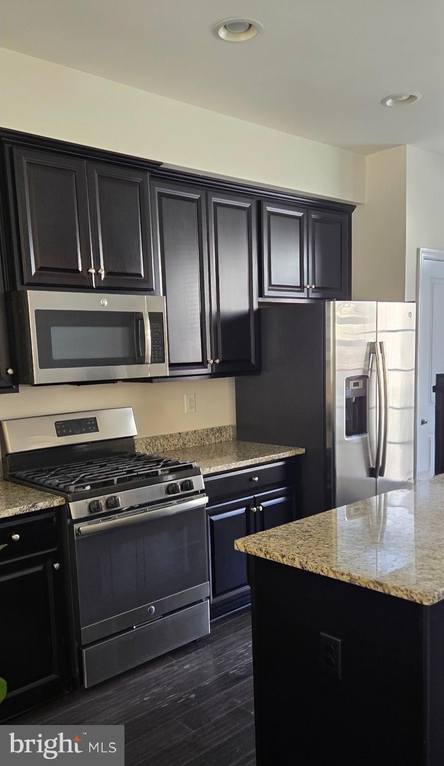 320 Rolling Valley Drive Fredericksburg, VA 22405 - Photo 2 of 12 a kitchen with kitchen island granite countertop stainless steel appliances and wooden cabinets