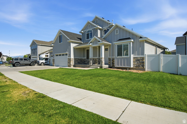 36 West Syracuse Road Vineyard, UT 84059 - Photo 5 of 56 Contemporary residential exterior featuring light gray siding and stone accents
