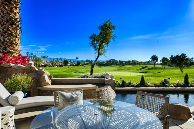 a view of a dining room with a table chairs and a floor to ceiling window