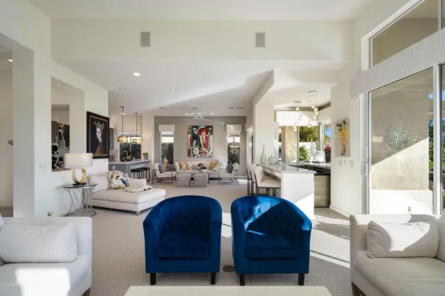 a dining room filled chandelier and wooden floor