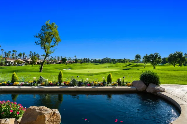 a kitchen with a refrigerator a sink and chairs