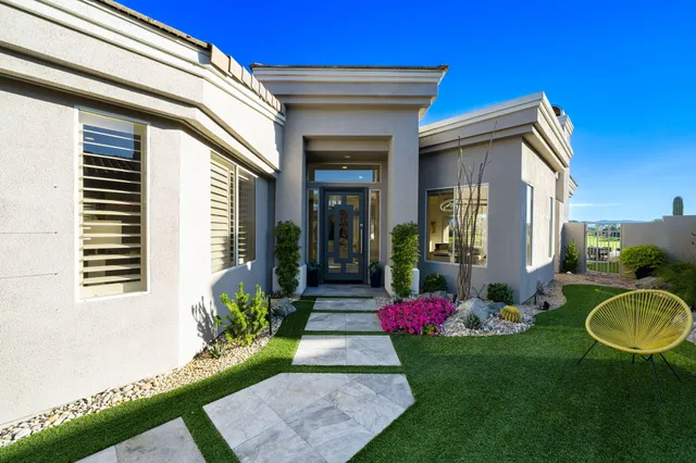 a living room with furniture a computer and a window