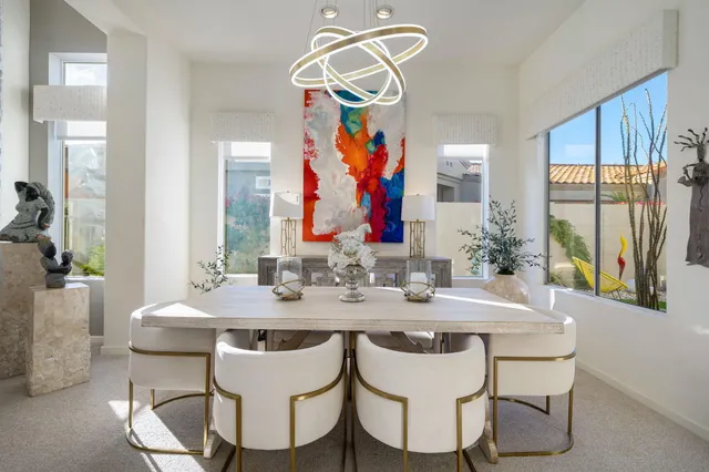 a living room with furniture and a view of kitchen