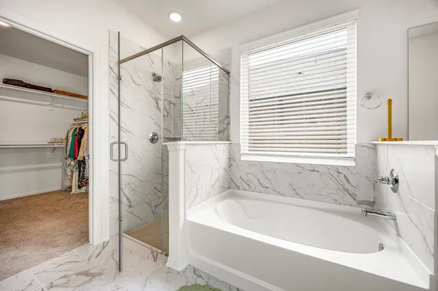 a bathroom with a bathtub and a shower