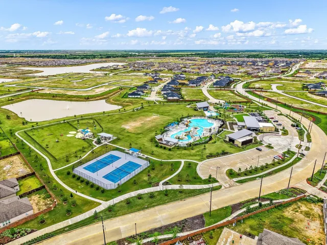 swimming pool view with a garden and outdoor seating