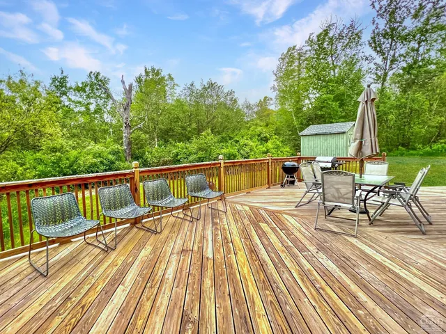 a view of balcony with chairs and wooden fence