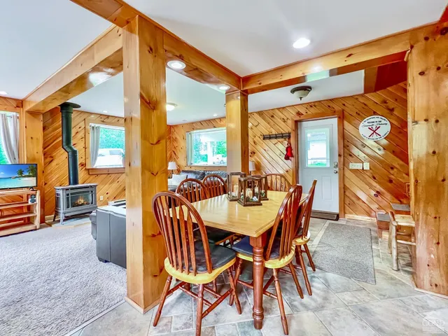 a dining room with furniture and a window