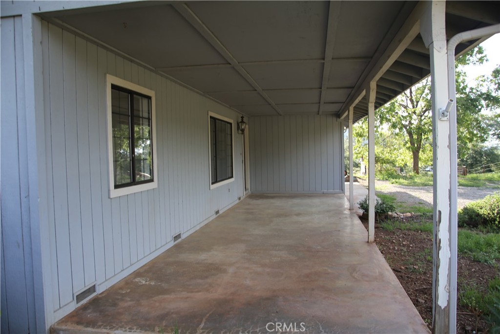 5636 East Whitlock Road Mariposa, CA 95338 - Photo 12 of 41 a view of a house with porch and backyard