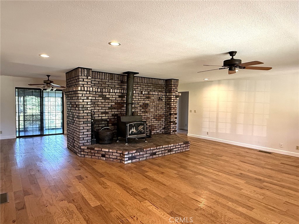 5636 East Whitlock Road Mariposa, CA 95338 - Photo 14 of 41 a view of a room with wooden floor and windows