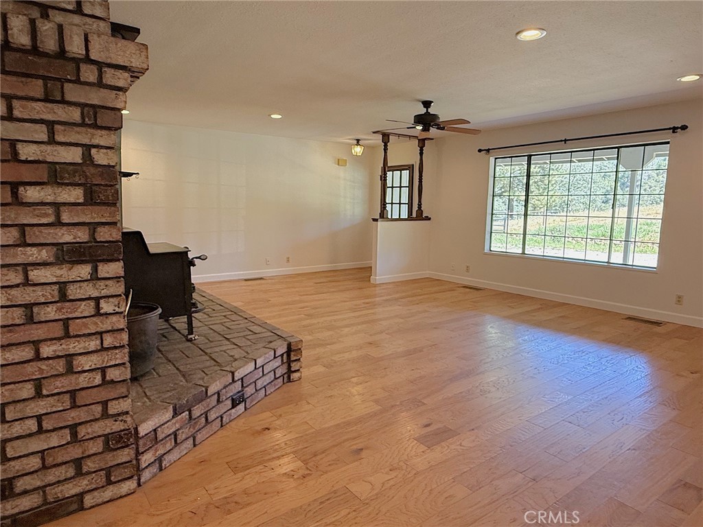 5636 East Whitlock Road Mariposa, CA 95338 - Photo 16 of 41 an empty room with windows and ceiling fan