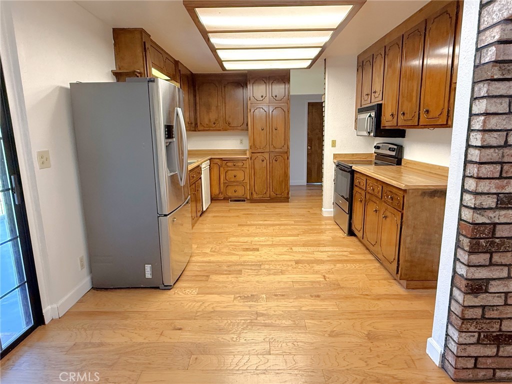 5636 East Whitlock Road Mariposa, CA 95338 - Photo 17 of 41 a kitchen with stainless steel appliances a refrigerator and a stove top oven
