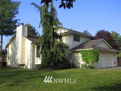 702 196th Place Southeast Bothell, WA 98012 - Photo 1 of 1 a front view of a house with a garden