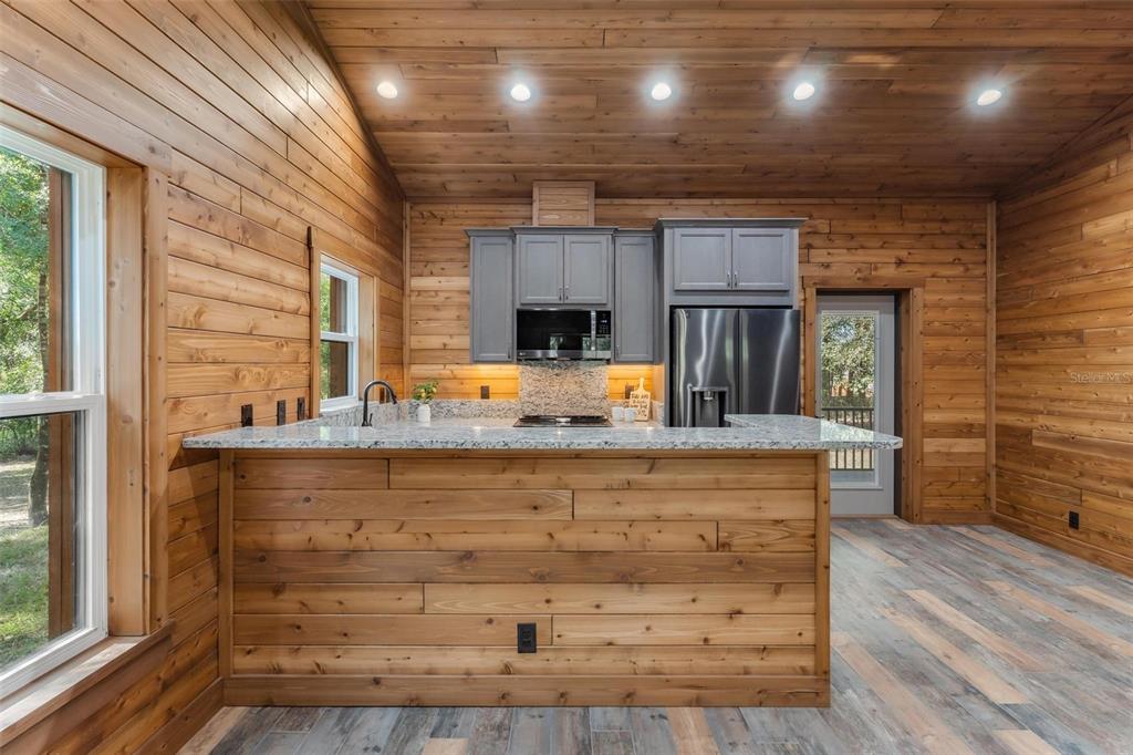 37590 Rolling Acres Road Lady Lake, FL 32159 - Photo 12 of 30 a view of kitchen with cabinets and wooden floor