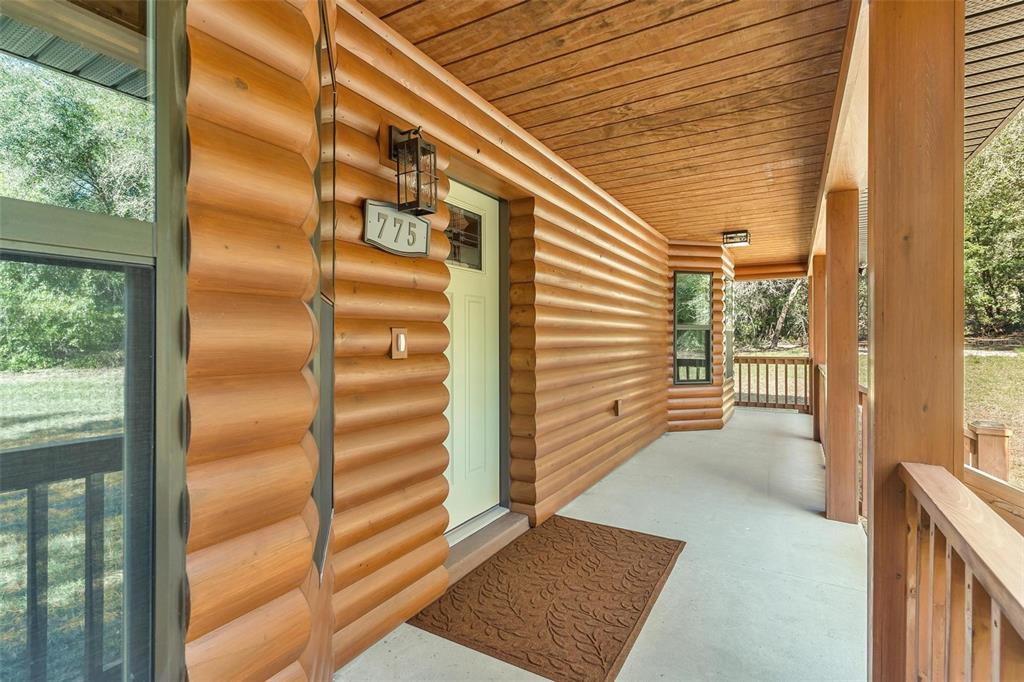 37590 Rolling Acres Road Lady Lake, FL 32159 - Photo 3 of 30 a view of a porch with a door and wooden floor