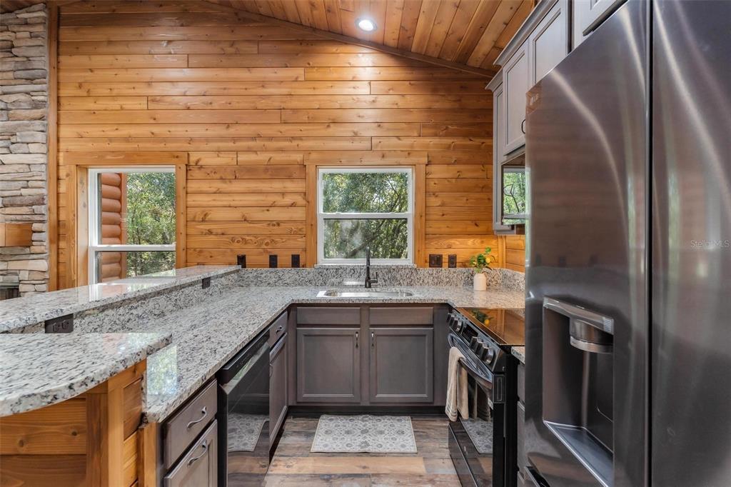 37590 Rolling Acres Road Lady Lake, FL 32159 - Photo 8 of 30 a kitchen with granite countertop a sink and a window