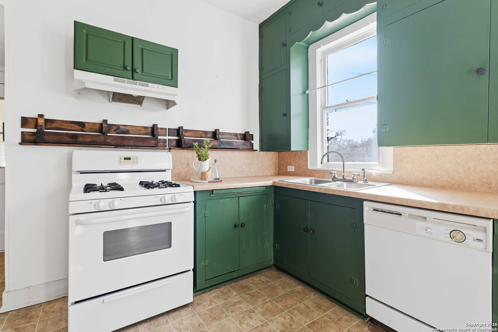 1409 21st Street Hondo, TX 78861 - Photo 11 of 25 a kitchen with a sink stove and microwave
