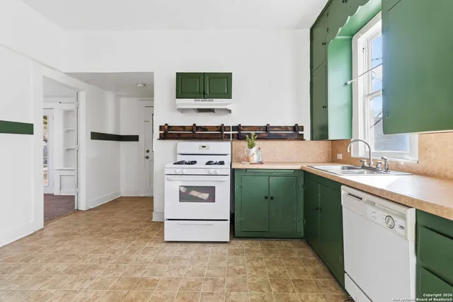a kitchen with a sink stove and refrigerator