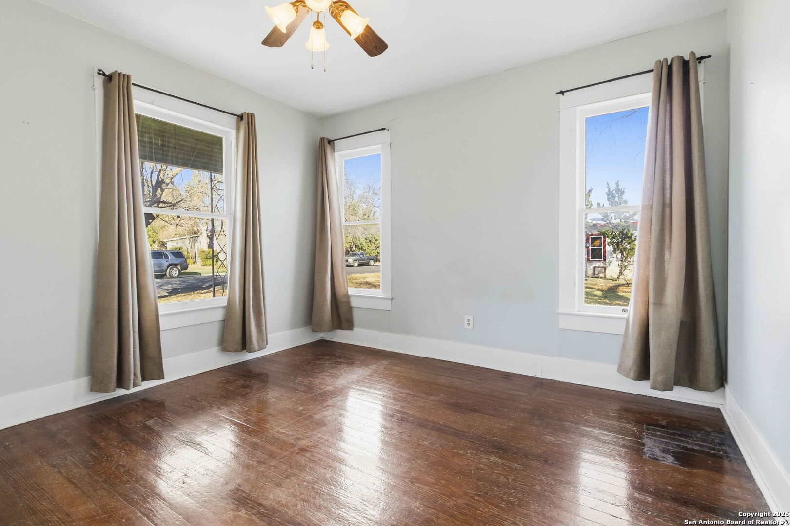 1409 21st Street Hondo, TX 78861 - Photo 21 of 25 a view of an empty room with wooden floor and a window