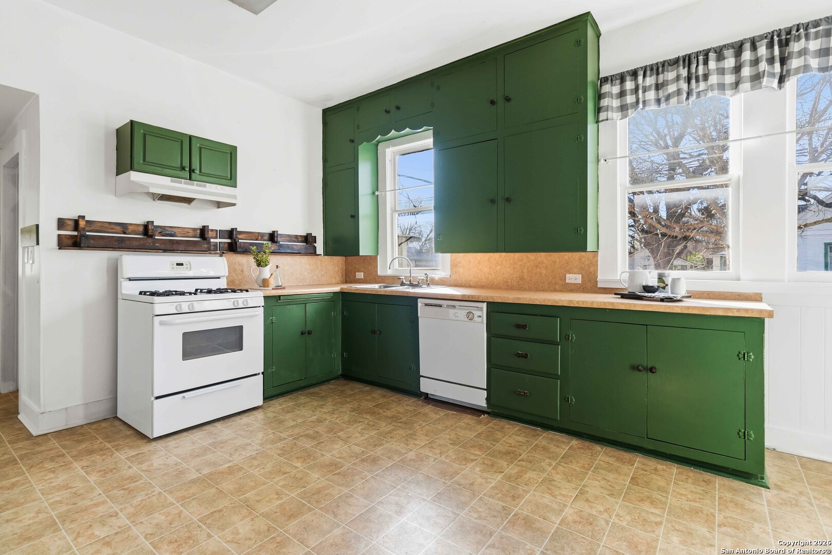 1409 21st Street Hondo, TX 78861 - Photo 9 of 25 a kitchen with a sink cabinets and a stove
