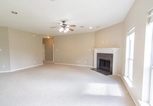 a view of empty room with a fireplace