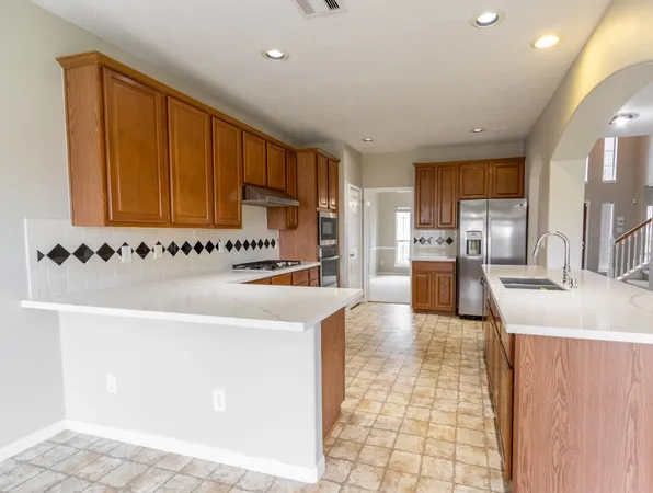 a kitchen with stainless steel appliances granite countertop a sink and a stove