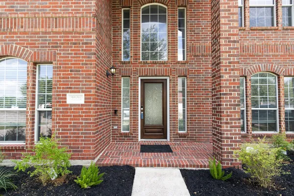 a front view of a house with a garden