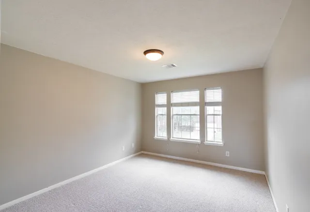 an empty room with windows and natural light