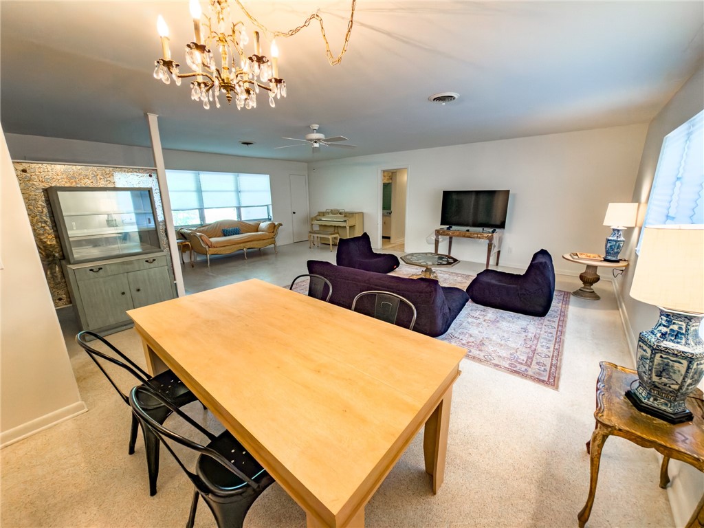 846 Date Palm Road Vero Beach, FL 32963 - Photo 7 of 29 a living room with furniture a chandelier and a flat screen tv
