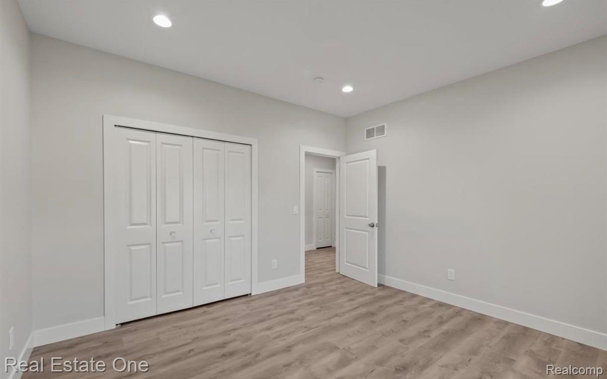 5636 Paris Street Sterling Heights, MI 48310 - Photo 22 of 37 Unfurnished bedroom with light wood-style flooring, a closet, and recessed lighting