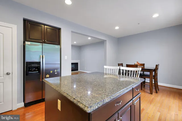 a kitchen with center island and stainless steel appliances
