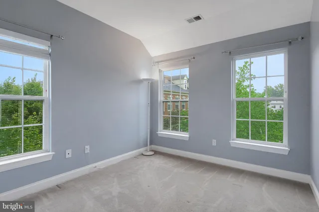 an empty room with windows and closet