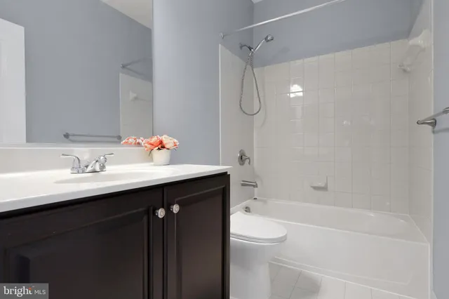a bathroom with a sink vanity mirror toilet and shower