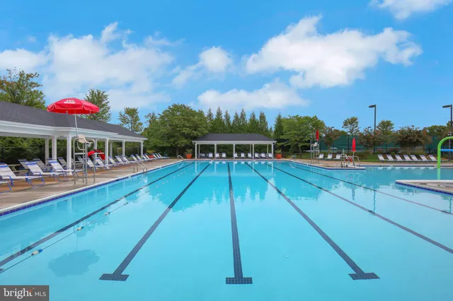 a swimming pool with outdoor seating