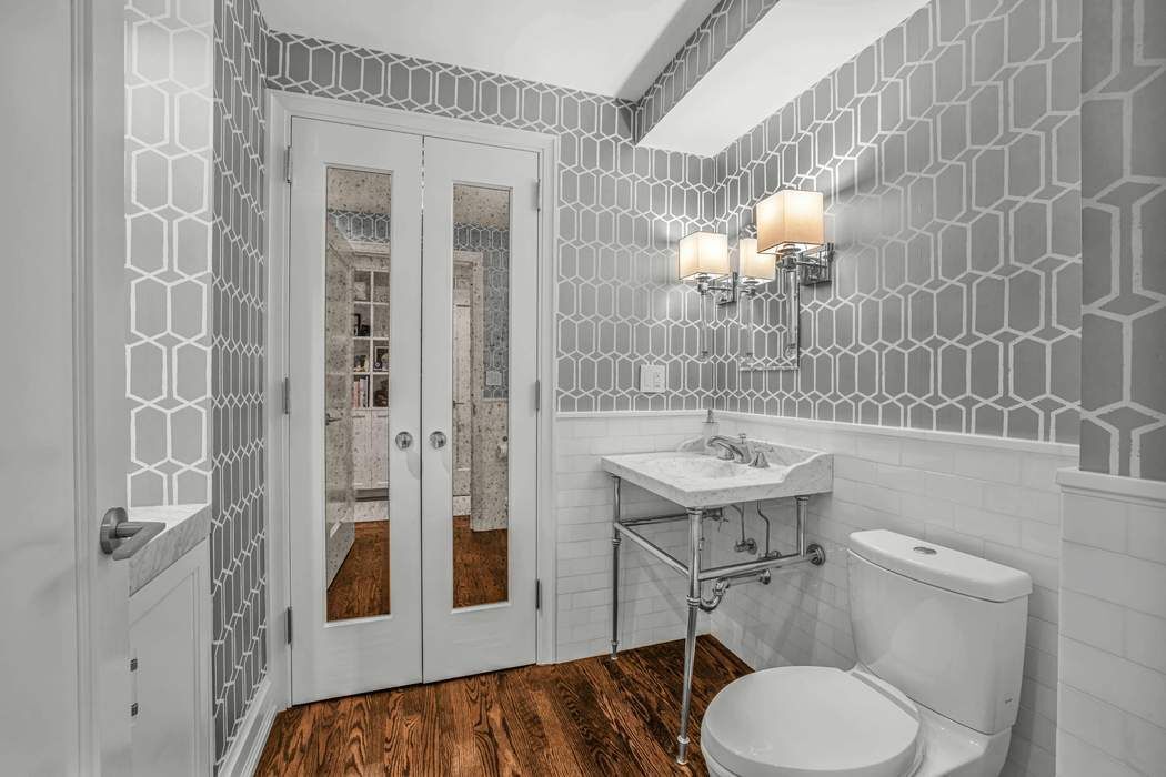 470 West 24th Street, Unit 7GJ Manhattan, NY 10011 - Photo 6 of 11 a bathroom with a sink toilet a mirror and shower