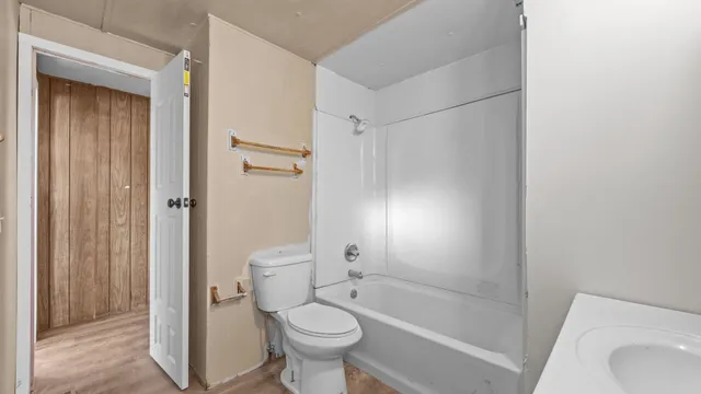 a bathroom with a shower a toilet and a bathtub