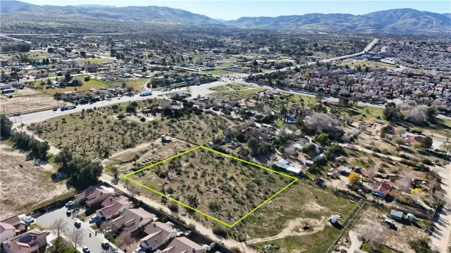 an aerial view of residential house and sandy dunes