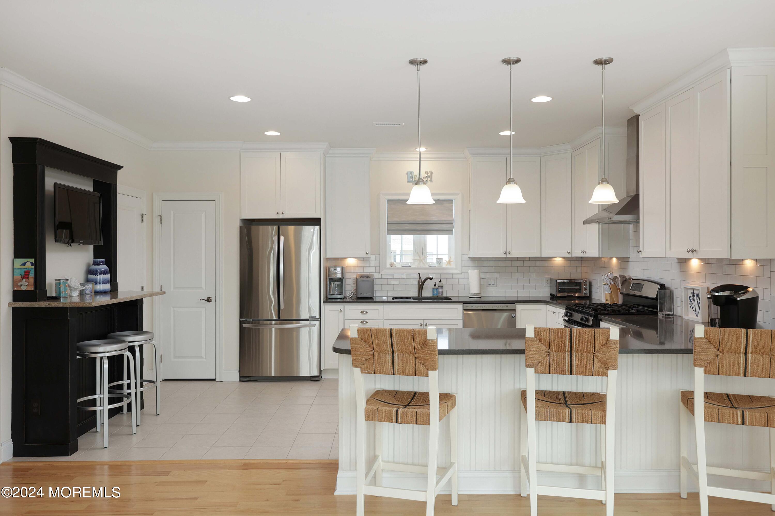 1607 Baltimore Avenue Lavallette, NJ 08735 - Photo 10 of 28 a kitchen with a refrigerator and a stove top oven