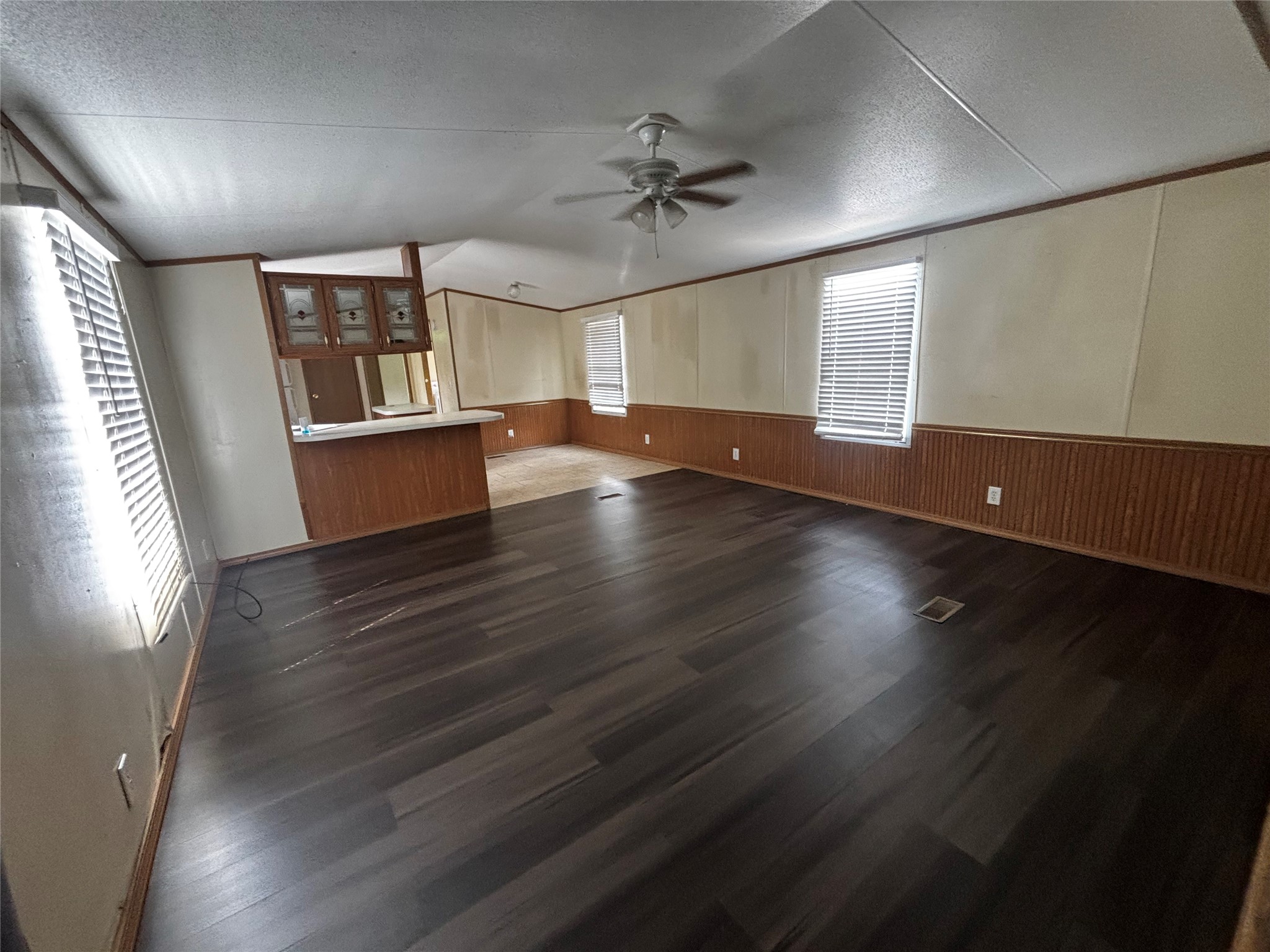 wooden floor in an empty room with a window