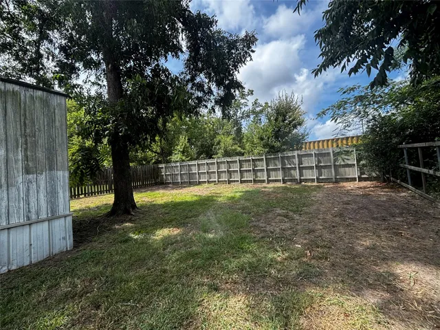 a view of a yard with a large trees
