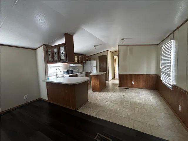 a large kitchen with kitchen island a sink dishwasher stove and cabinets