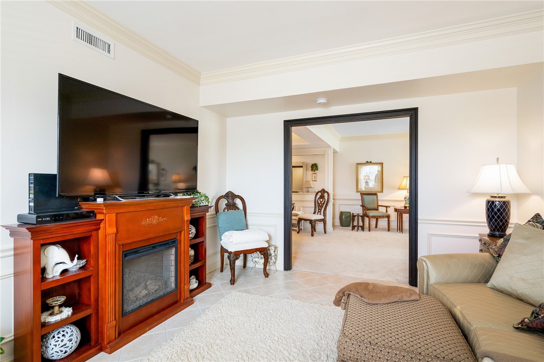 650 Beach Road, Unit 245 Vero Beach, FL 32963 - Photo 17 of 32 a living room with furniture a flat screen tv and a fireplace