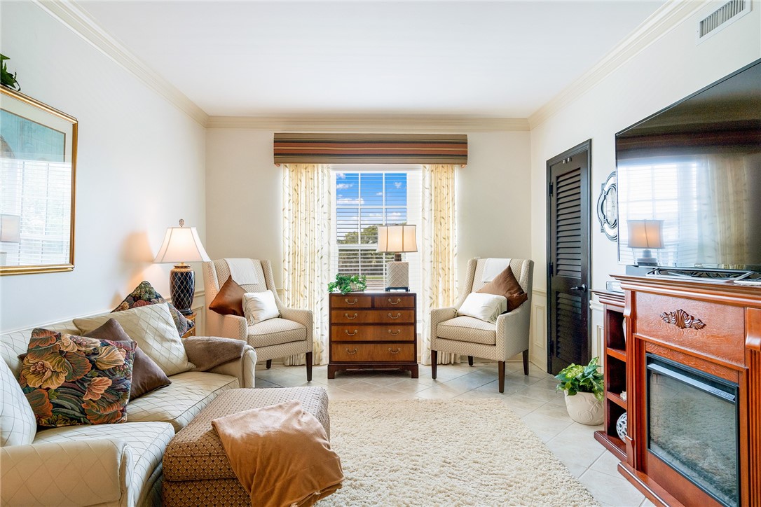 650 Beach Road, Unit 245 Vero Beach, FL 32963 - Photo 18 of 32 a living room with furniture fireplace and a large window