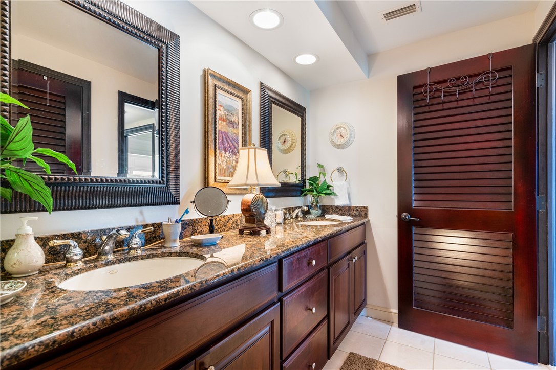 650 Beach Road, Unit 245 Vero Beach, FL 32963 - Photo 19 of 32 a bathroom with a granite countertop sink and a mirror