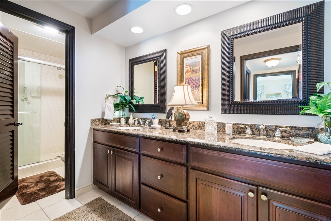 650 Beach Road, Unit 245 Vero Beach, FL 32963 - Photo 20 of 32 a bathroom with a double vanity sink and a mirror